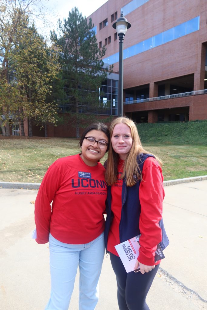 two Husky Ambassadors standing near the HBL library